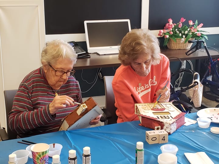 Arbour Square (PA) residents working hard on painting their gingerbread houses.