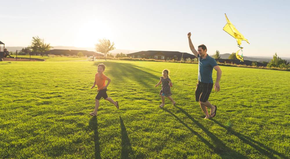 A resident flying kites with his children at a park near Amherst Oaks in Dallas, Texas
