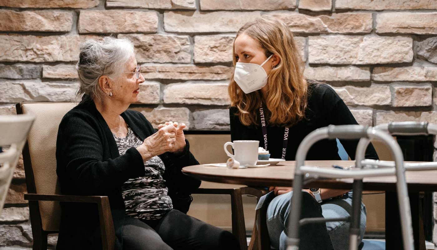 Student talking with a resident at The Pillars of Mankato in Mankato, Minnesota
