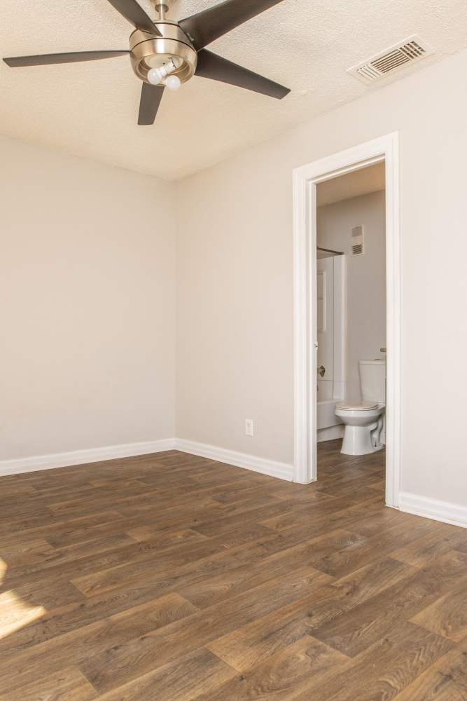 Apartment bedroom with a ceiling fan at Fredericksburg Place Apartments in San Antonio, Texas