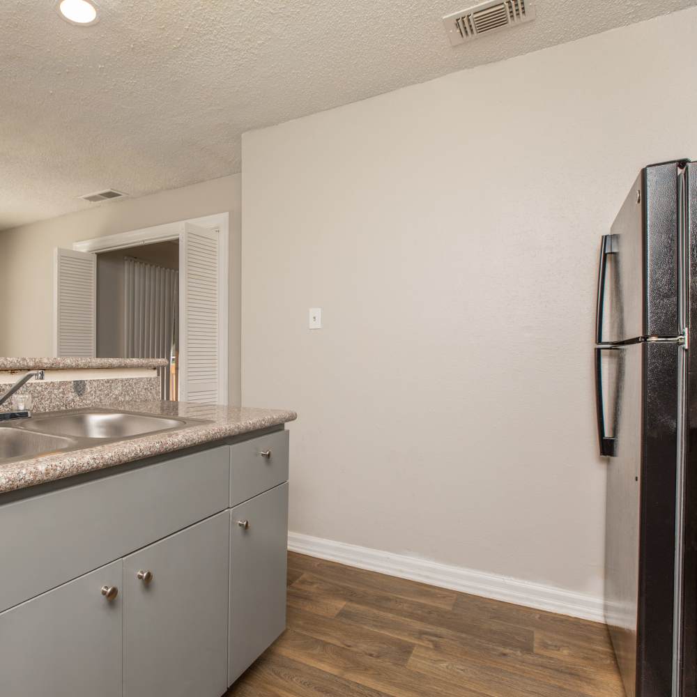 Apartment kitchen with sink at Fredericksburg Place Apartments in San Antonio, Texas