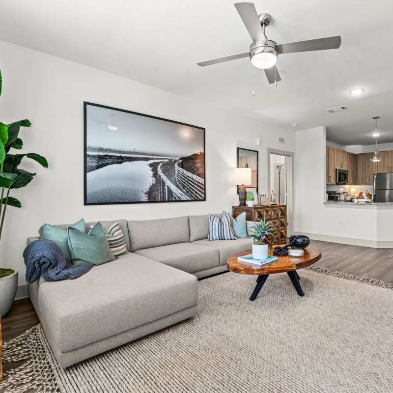 Cozy living room with large couch, and coffee table at Watersound Origins Crossings in Inlet Beach, Florida