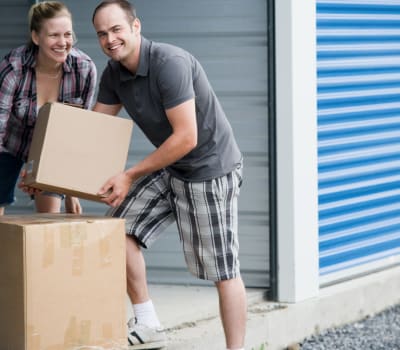 Couple with boxes near self storage units at Wilhelm Storage and Fuels in Flint, Michigan