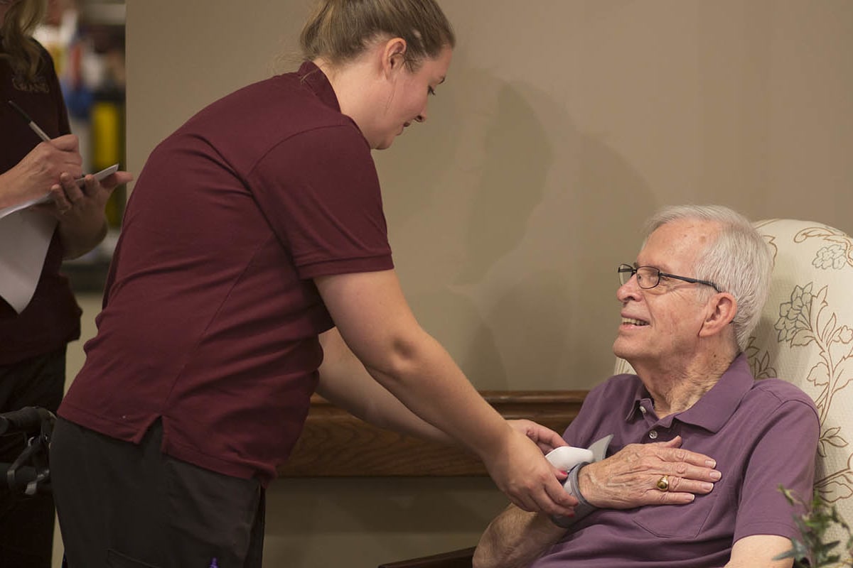 A resident and staff at Oxford Glen Memory Care at Grand Prairie in Grand Prairie, Texas