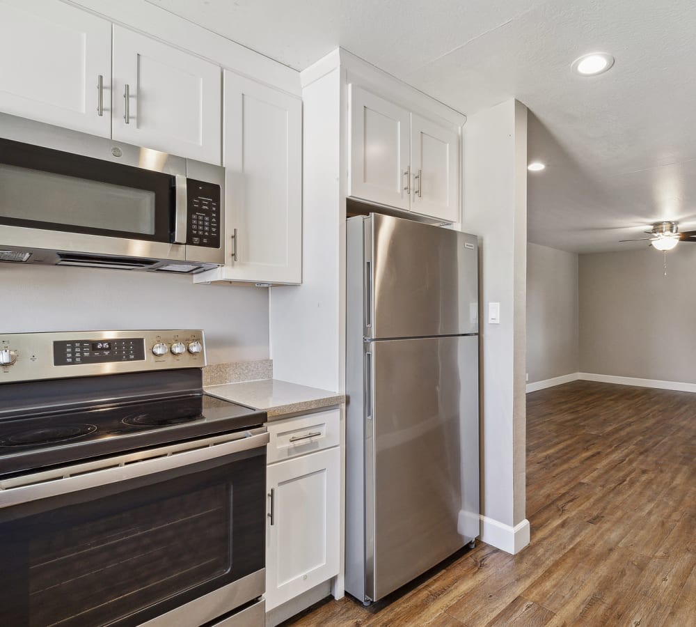 Upgraded kitchen with white cabinets and stainless steel appliances