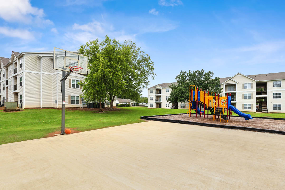 Outdoor basketball court and kids' playground at Barrington Parc in Moody, Alabama