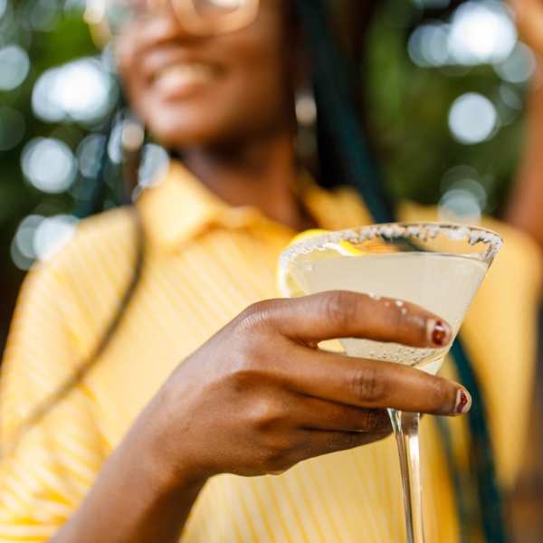 A resident enjoys a cocktail near Attain at Quarterpath, Williamsburg, Virginia