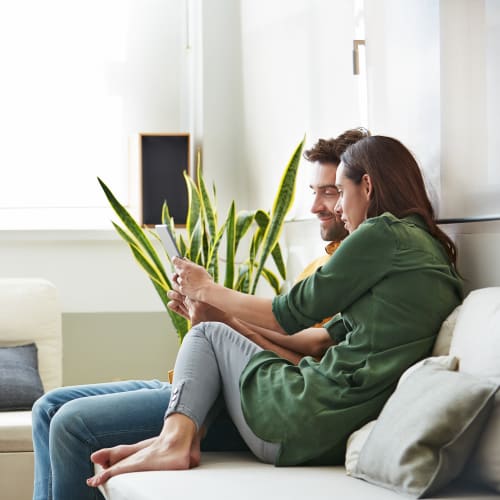 Residents looking at a tablet in a home at Naval Amphibious Base in San Diego, California