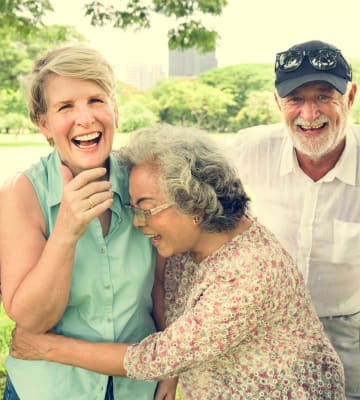 Happy residents hugging at Honeysuckle Senior Living in Hayden, Idaho
