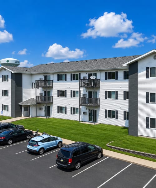 Exterior view of the community building with parking spaces at Valley View Apartments in Cedar Rapids, Iowa