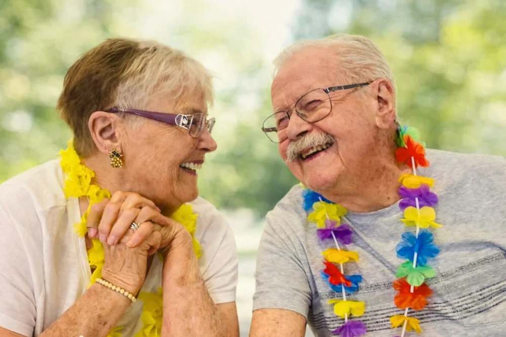 Two residents smiling outdoors at Roseville Commons Ray Stone Inc. in Sacramento, California