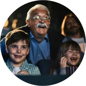 Resident with grandchildren in movie theater near Sunstone Village in Denton, Texas