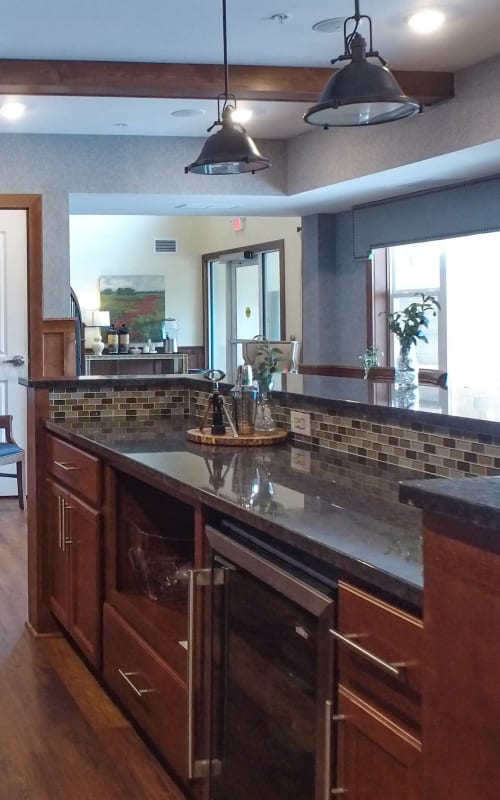 Community room with spacious kitchen and granite countertops at The Pillars of Mankato in Mankato, Minnesota
