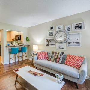 Living room with modern furnishings and bright accessories at UCE Apartment Homes in Fullerton, California