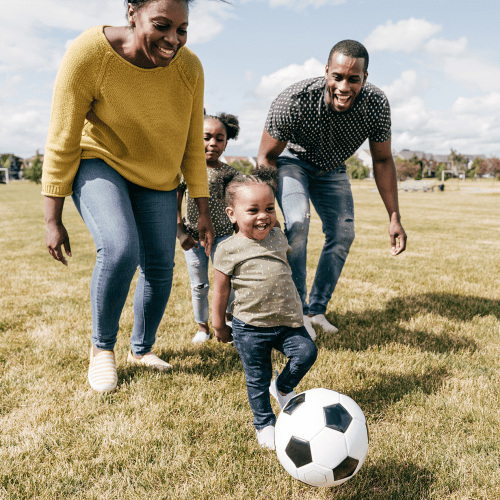 A family playing soccer at Gela Point in Virginia Beach, Virginia