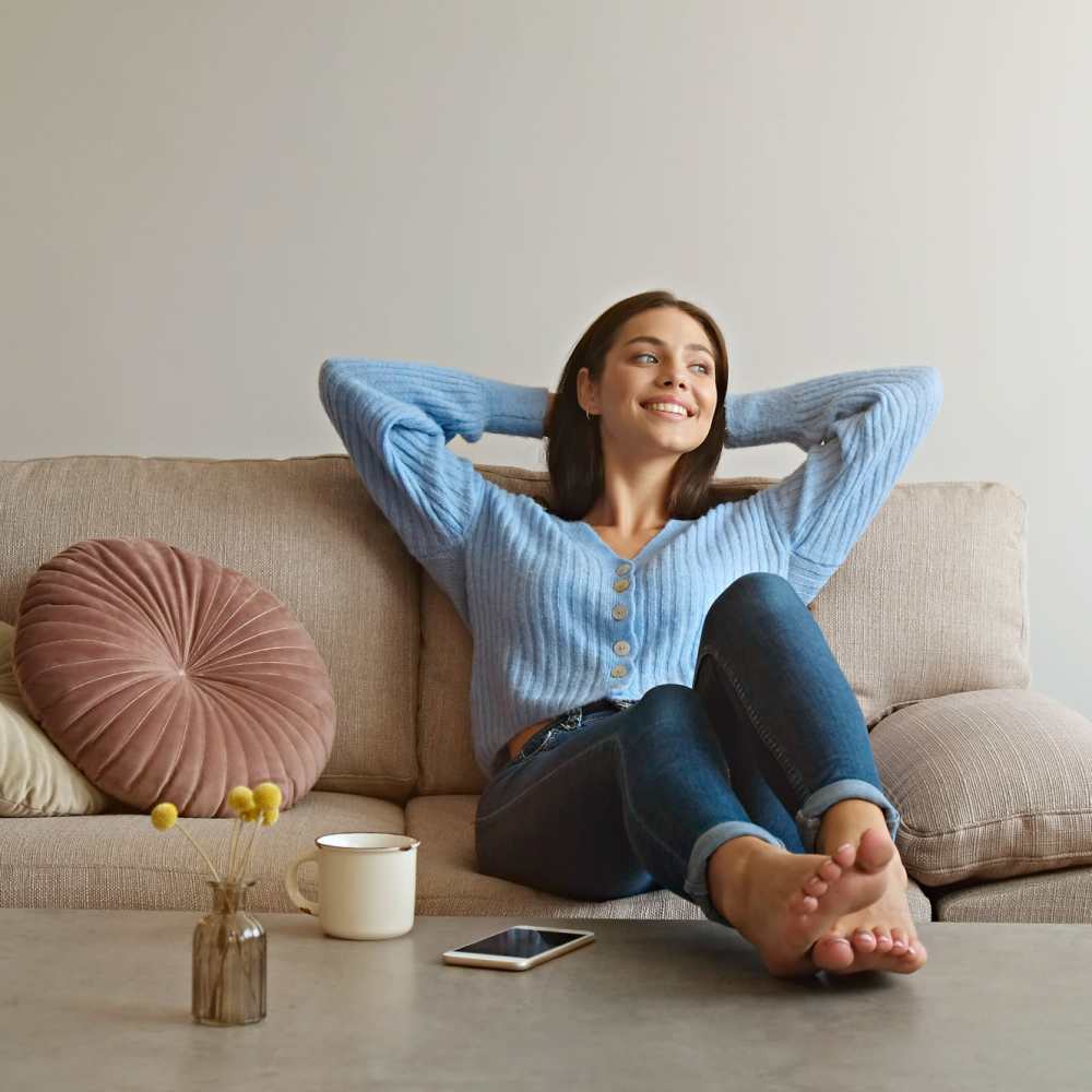 Resident laying back on the couch at Tucasa Townhomes in Irving, Texas