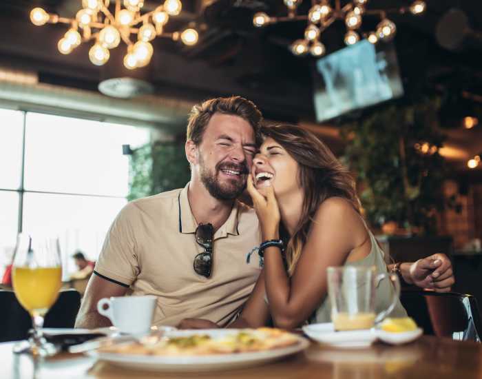 A couple enjoying a joyful moment together as they savor a meal at a cafe nearby Valparaiso, Indiana