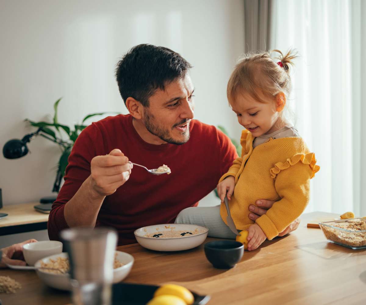 A resident man feeding food to his daughter at Annhurst in Belcamp, Maryland