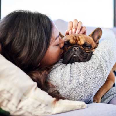 Woman holding a dog in a pet-friendly apartment at The Madison in Charlotte, North Carolina