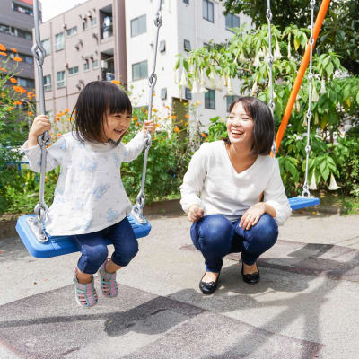 A mother and her daughter having fun at a playground near Eagleview in Joint Base Lewis McChord, Washington