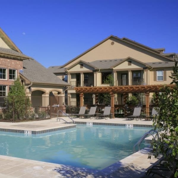 Resort-style swimming pool at Wood Crest Apartment Homes in Chalmette, Louisiana