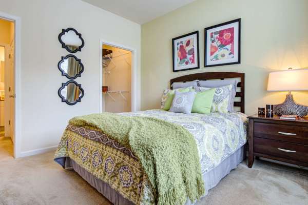 Bedroom with a bed and night stand at Preserve at Steele Creek in Charlotte, North Carolina