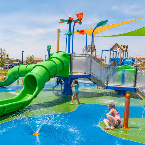 Kids playing at a splash park with water slide at Mountain View in Fallon, Nevada