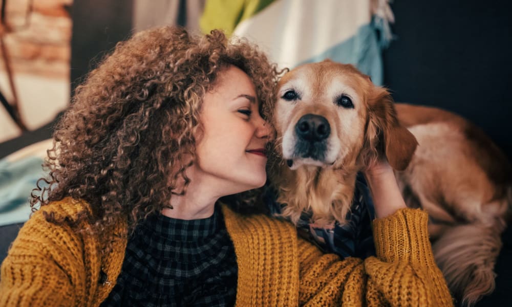 A woman petting a dog at Bellevue Mill in Hillsborough, North Carolina