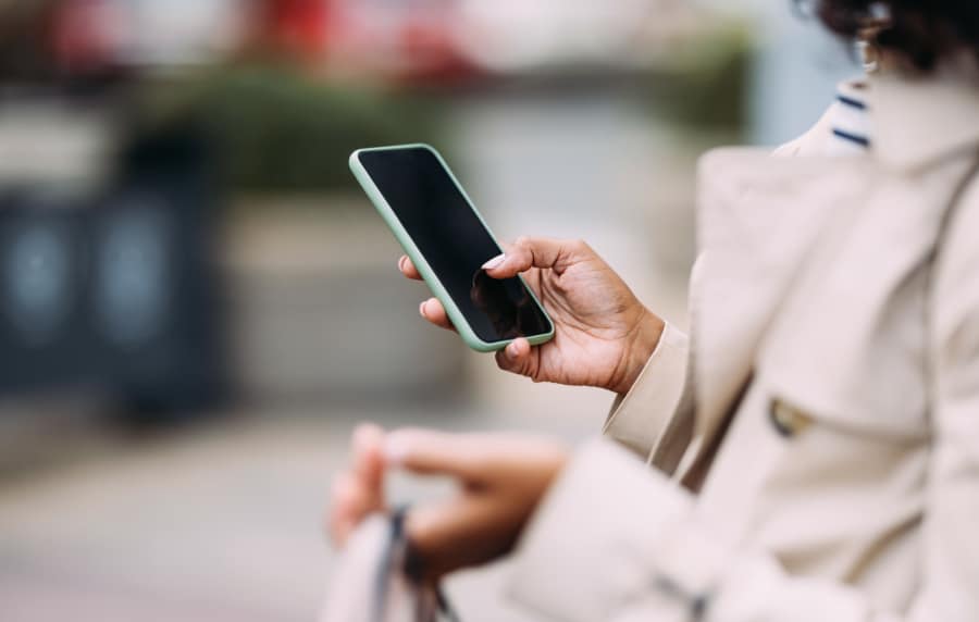 Resident using her mobile near Nantucket at Fannin Station in Houston, Texas