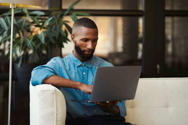 Man working on his laptop at Raystone Apartments in Phoenix, Arizona