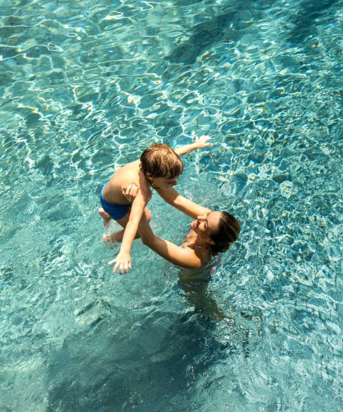 Resident and her kid playing in the pool at Reserve at South Coast in Santa Ana, California