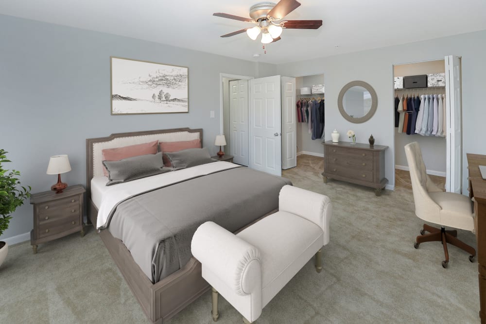 Staged bedroom with desk and 2 closets at Woodacres Apartment Homes in Claymont, Delaware