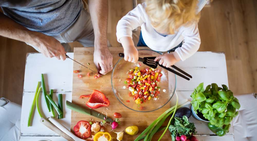 A parent and child preparing a health meal at Baxter Apartments in Bozeman, Montana