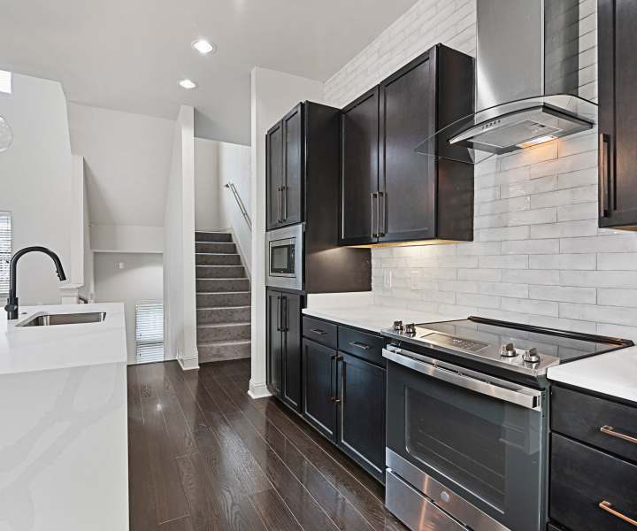 Kitchen with full height cabinet and stainless-steel appliances at Domain Memorial in Houston, Texas