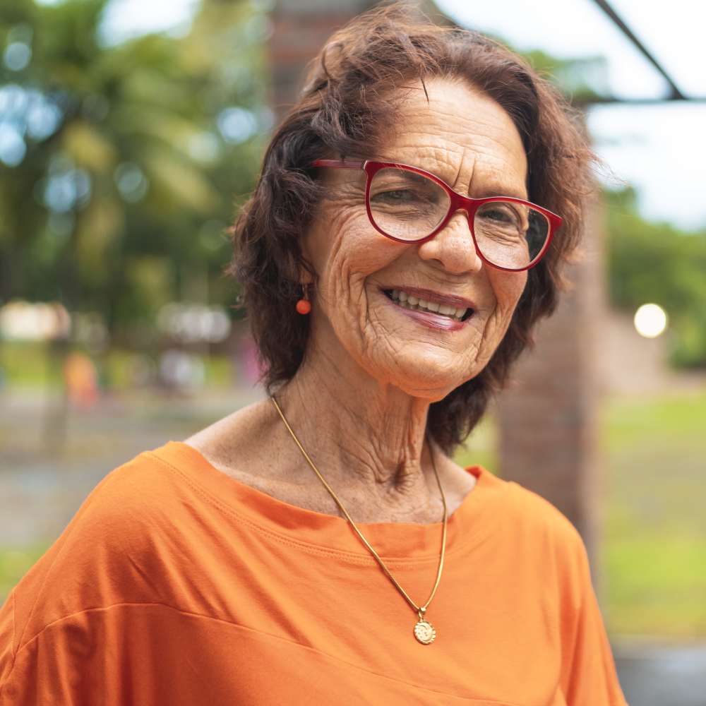 Resident senior woman smiling outdoors at Clearwater at The Arboretum in Austin, Texas