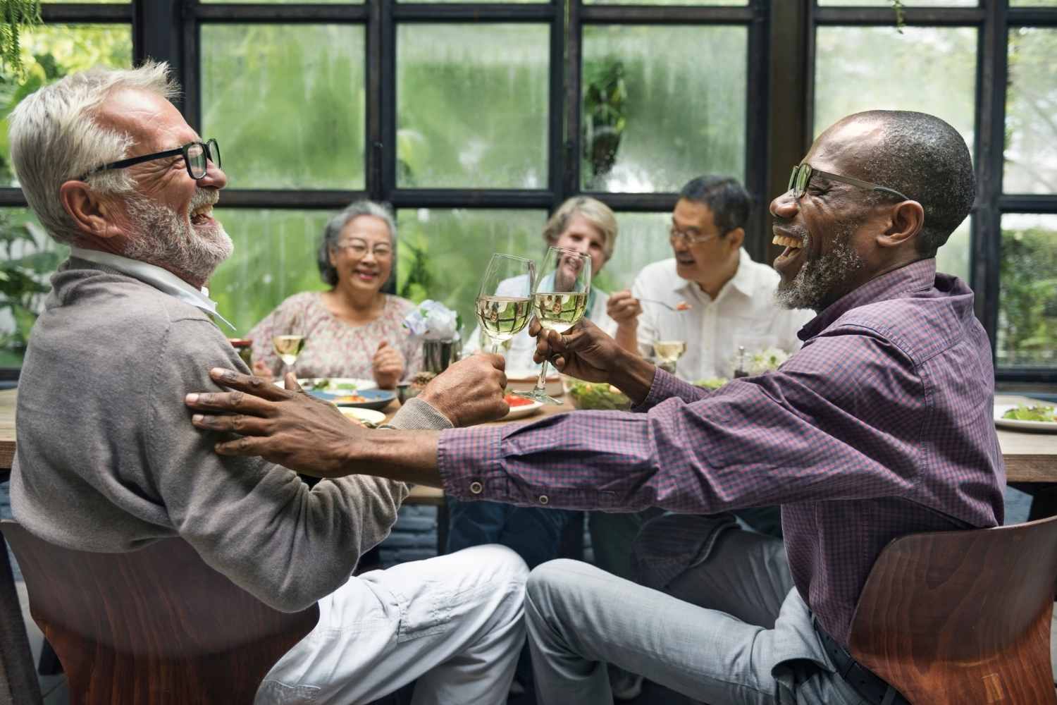 Residents enjoying their meal in a restaurant near Clinton West Apartments in Stockbridge, Michigan