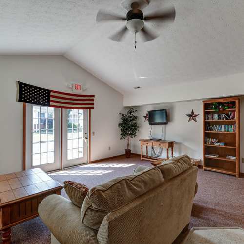 Sofa with decorative pillows and ceiling fan at Clover Ridge in McConnelsville, Ohio