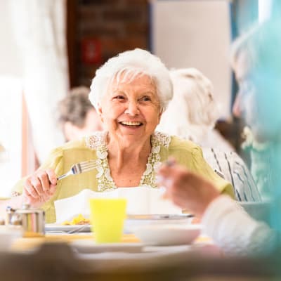 A resident enjoys dining at First & Main of Bloomfield Township in Bloomfield Township, Michigan