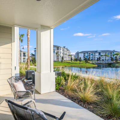 Private apartment patio with view of the lake at Champions Vue Apartments in Davenport, Florida