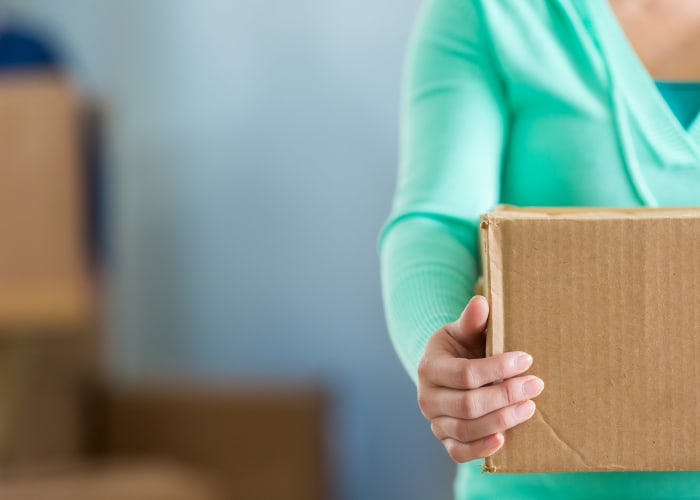 Woman holding a box at Squirrel Storage Des Moines
