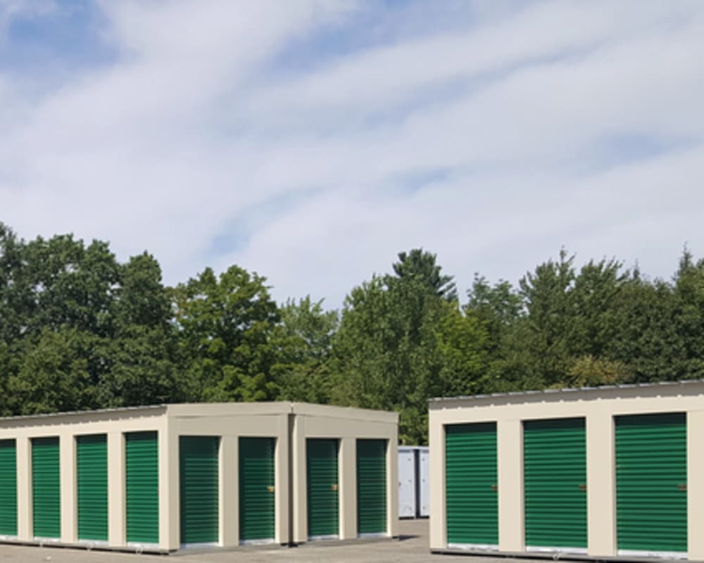 A row of outdoor units with green doors at 603 Storage - Route 27 in Raymond, New Hampshire