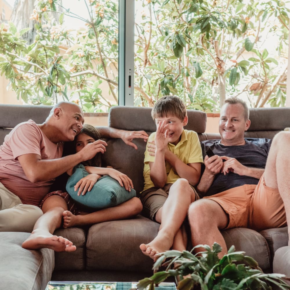 Family on their couch at Alamar at Fernwood Forest in Indiantown, Florida