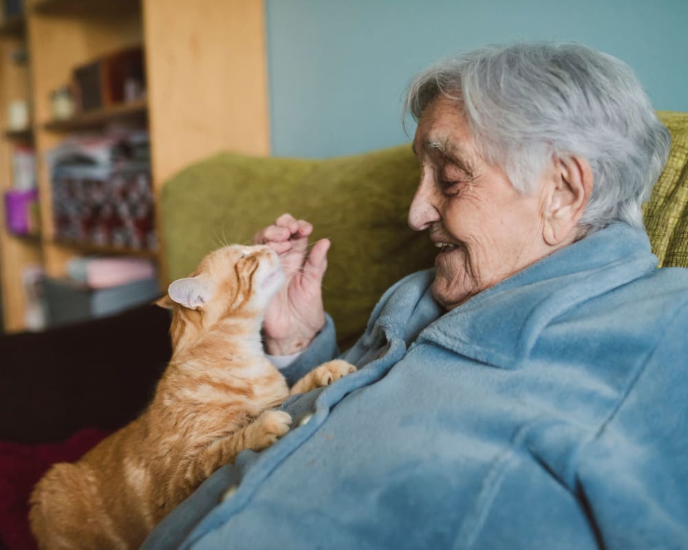 An elderly woman with her cat at Chateau Gardens Memory Care in Springfield, Oregon