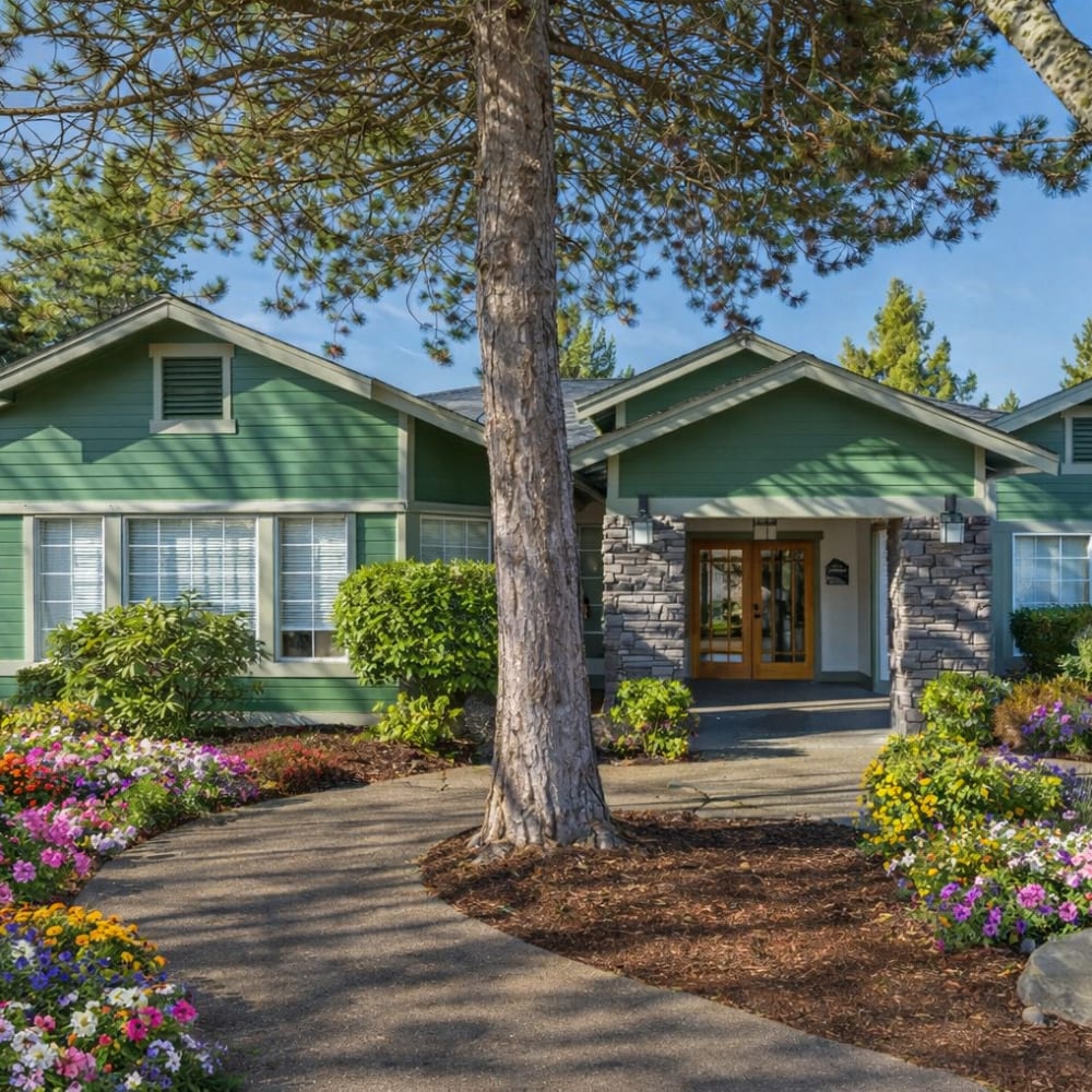 A couple sits by an outdoor fireplace, sharing a warm moment at Terravista in Tacoma, Washington