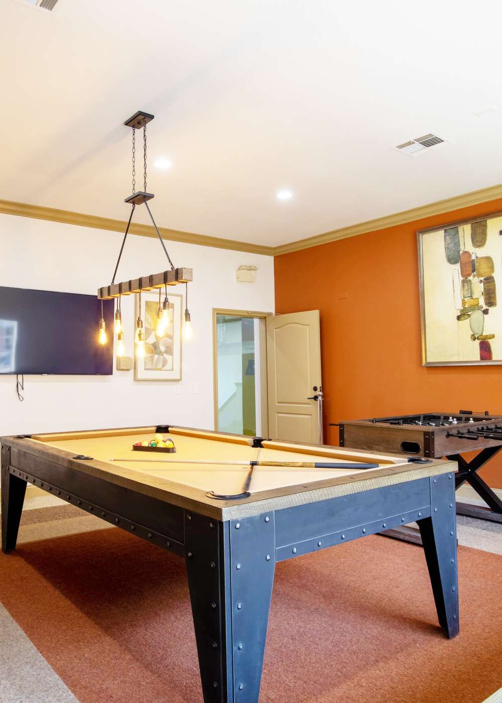 Community game room with billiards table and foosball at Brixton in Round Rock, Texas
