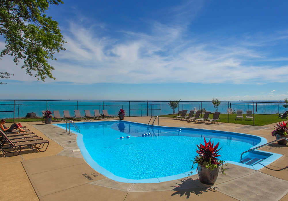 Beautiful swimming pool with lounge chairs at 12000 Edgewater in Lakewood, Ohio