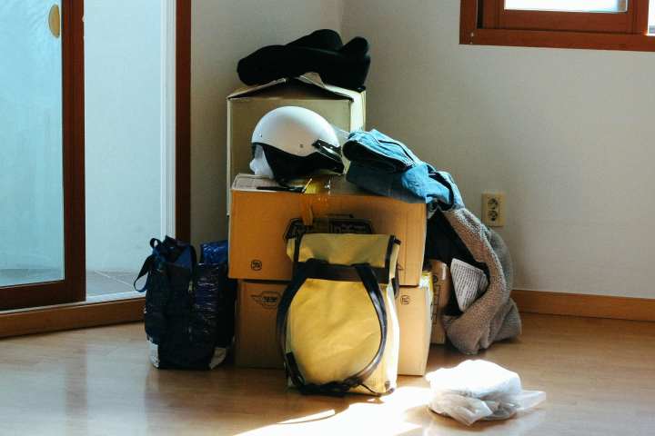 summer outdoor gear stacked up in a corner with boxes