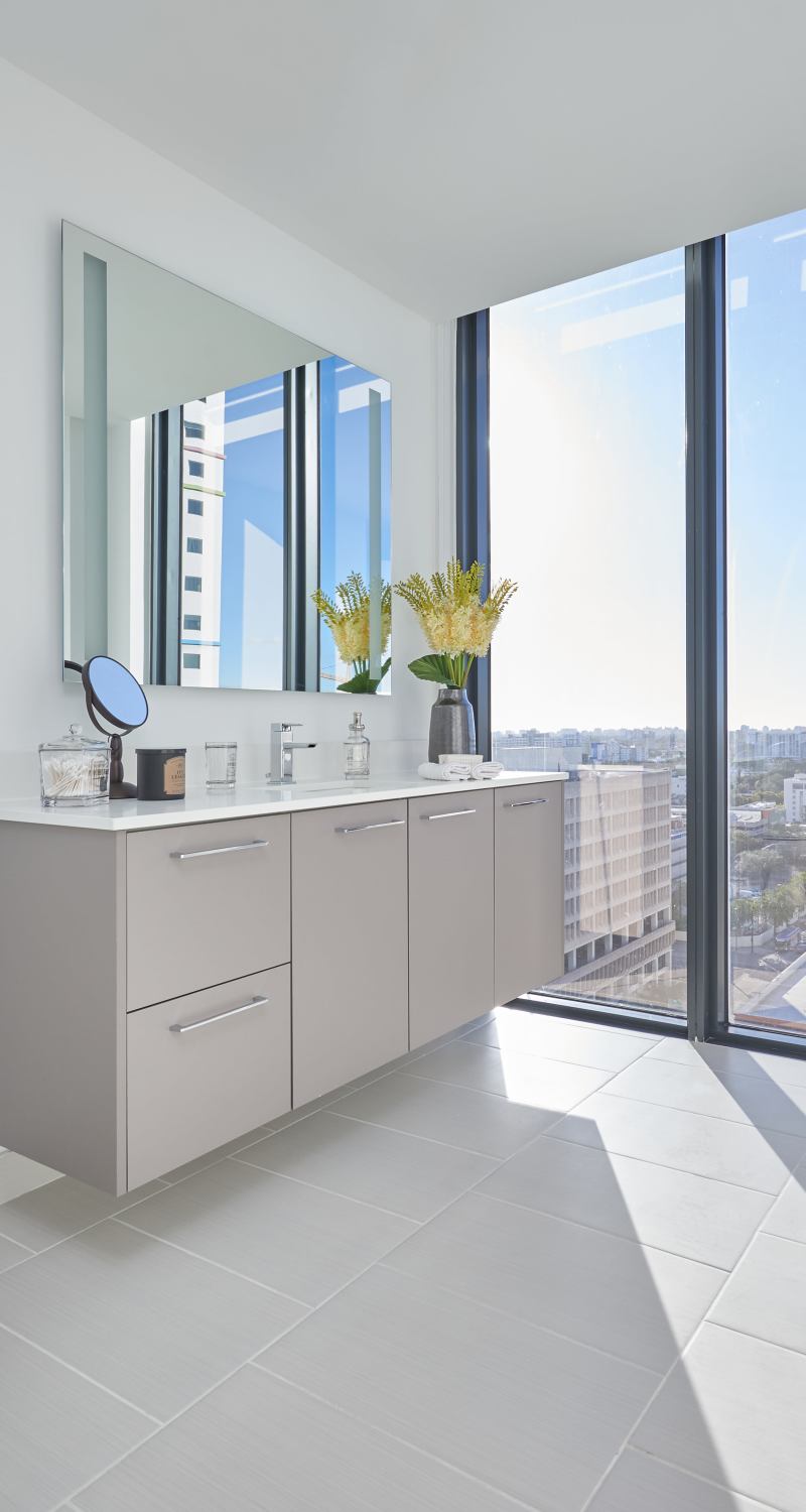 Modern bathroom with a large mirror at ParkLine Miami in Miami, Florida