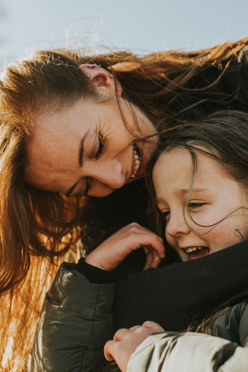 Resident mother giving her daughter a hug at The Links at CenterPointe Townhomes in Canandaigua, New York