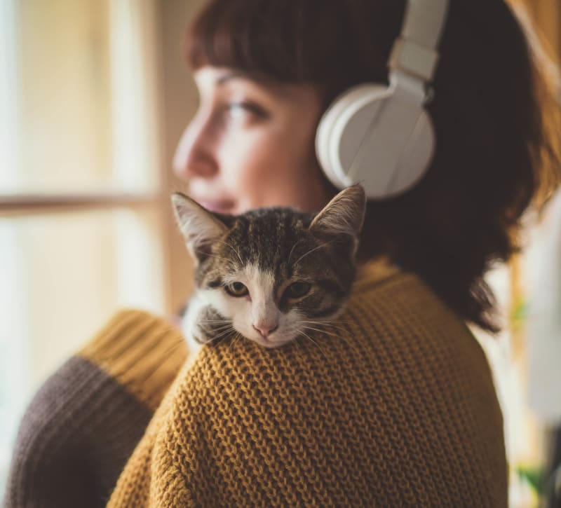 Resident listen to music from home with her cat at Royal James Plaza in Columbus, Ohio
